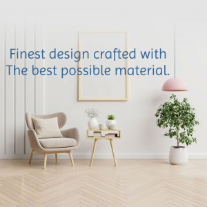 A stylish living room with a comfortable armchair, plant, and framed artwork.