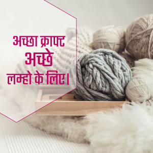 A wooden tray filled with various colors and textures of yarn and knitted fabric.