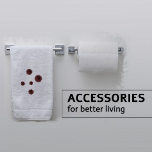 White towel with brown spots and a roll of toilet paper on a silver rack in a bathroom.