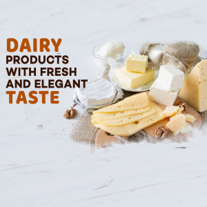 Assortment of cheeses and butter on a wooden board with linen cloth