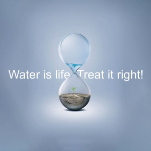 Hourglass with water and a small plant growing in the sand, symbolizing the importance of water.