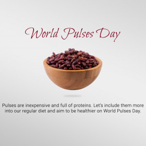 A wooden bowl filled with red lentils with the text 'World Pulses Day'