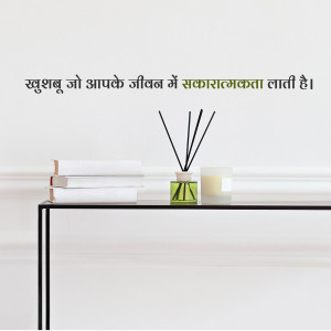 Diffuser sticks in a glass bottle with books and candles on a shelf