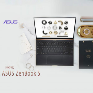 Overhead view of an ASUS ZenBook S laptop with design elements and accessories.