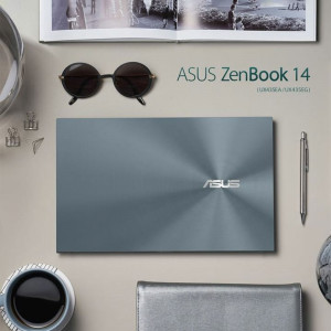 ASUS ZenBook 14 laptop with accessories on a neutral background