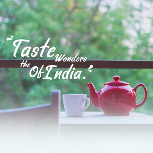 A red teapot and a cup of tea with a scenic view in the background.