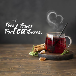 A glass of red tea with cinnamon sticks and fresh leaves on a wooden surface.