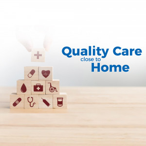 Wooden blocks stacked to represent healthcare with a hand reaching for a plus sign.