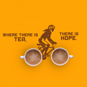Top-down view of two cups of tea forming the wheels of a bicycle with a cyclist silhouette, with text 'Where There Is Tea, There Is Hope'.