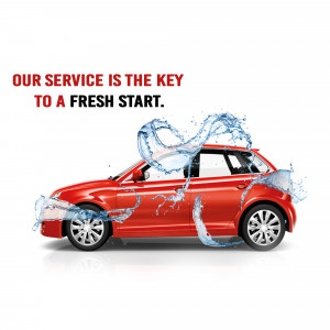 Red car being washed with water splash, symbolizing a fresh start and car cleaning services.