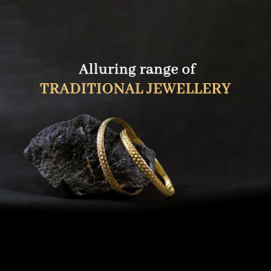 Close-up of gold bangles resting on a dark rock against a black background.