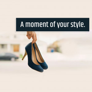 A pair of navy blue high heels held up by a hand with a text overlay.