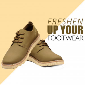 Pair of olive green leather shoes with a beige sole on a two-tone background.