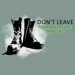 Pair of worn combat boots with motivational text