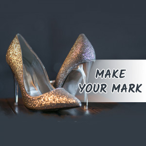 Pair of glittering high heel shoes with the text 'Make Your Mark'