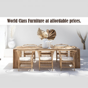 A well-lit dining room with a large wooden table and wicker chairs.