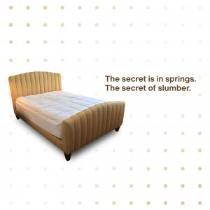 A comfortable bed with a tufted headboard in a room with a dotted background.