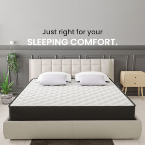 A modern bedroom featuring a comfortable mattress and bedding.