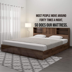 A modern bed with a comfortable mattress and a headboard with storage shelves.