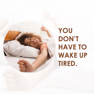 Woman stretching in bed with text 'You Don't Have To Wake Up Tired.'