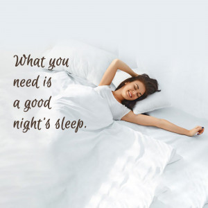 Woman stretching in bed, enjoying a peaceful sleep.