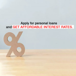 Wooden percentage sign with text promoting affordable personal loan interest rates.
