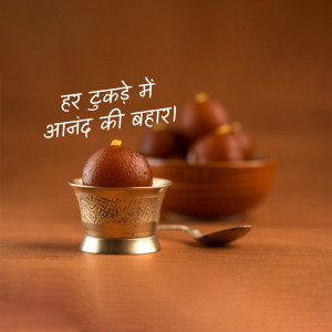 Close-up of Gulab Jamun in a silver bowl with a blurred background of more Gulab Jamun.
