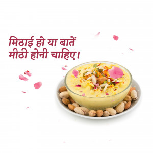 A bowl of creamy Indian dessert, likely Rasmalai, garnished with nuts and rose petals.