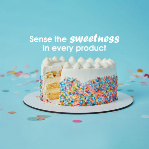 A slice of vanilla cake with colorful sprinkles and white frosting on a white plate.