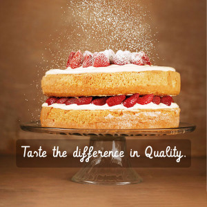A two-layer strawberry shortcake with powdered sugar, strawberries, and whipped cream on a glass cake stand.