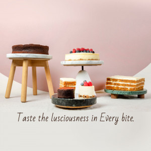 Assortment of beautifully decorated cakes on marble and wooden stands