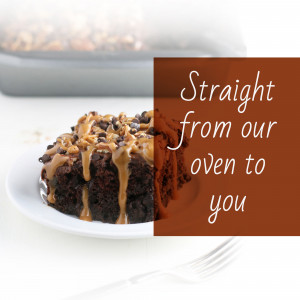 Close-up of a slice of chocolate brownie with caramel drizzle on a white plate