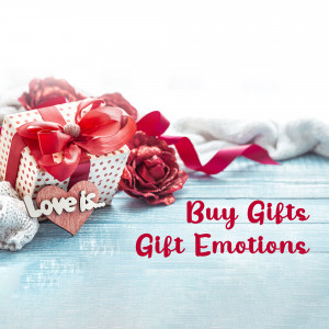 Gift box with red roses and a heart-shaped tag saying 'Love is'