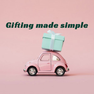 A pink toy car carrying a gift box on its roof against a pink background.