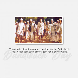 Black and white photograph of Mahatma Gandhi leading the Dandi March with followers.
