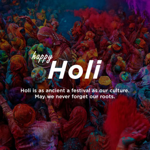 Crowd of people celebrating Holi with vibrant colors