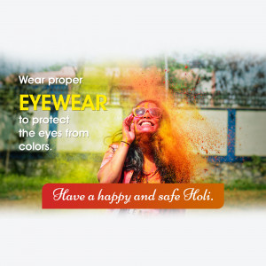 Woman celebrating Holi with colorful powder and wearing protective eyewear.