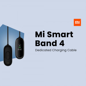 Mi Smart Band 4 and its dedicated charging cable on a light blue background