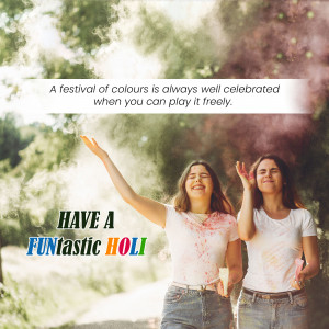 Two women celebrating Holi with colored powder, smiling and enjoying the festival.