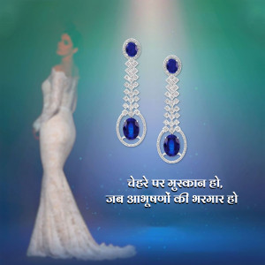 Woman wearing long sapphire and diamond earrings with a flowing gown