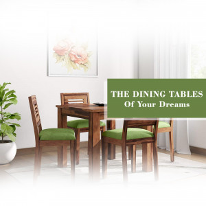 A modern dining table set with four chairs in a well-lit room.