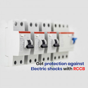 Close-up of a row of white RCCB circuit breakers on a wall, with text promoting electrical shock protection.