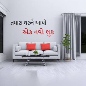 A minimalist living room with a grey sofa, red pillows, and a small coffee table.