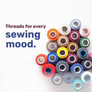A collection of colorful spools of sewing thread arranged in a visually appealing pattern.