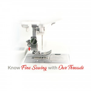 Close-up of a white sewing machine with red accents and threads