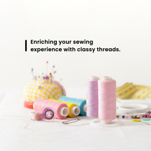 Colorful sewing threads, needles, and pins on a white surface.