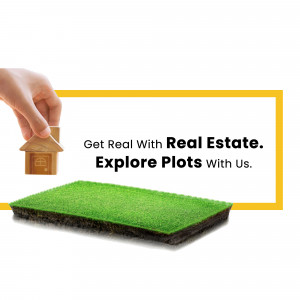 Hand holding a miniature house over a green plot of land with text 'Get Real With Real Estate. Explore Plots With Us.'