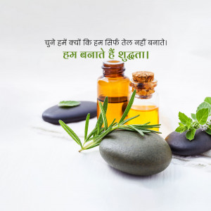 Brown glass bottle of essential oil with rosemary and stones