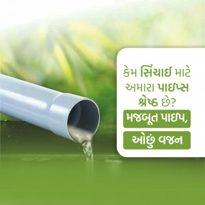 Close-up of water flowing through a white irrigation pipe in a green field.