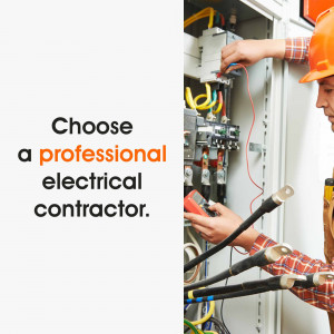 Electrician working on electrical panel with safety equipment